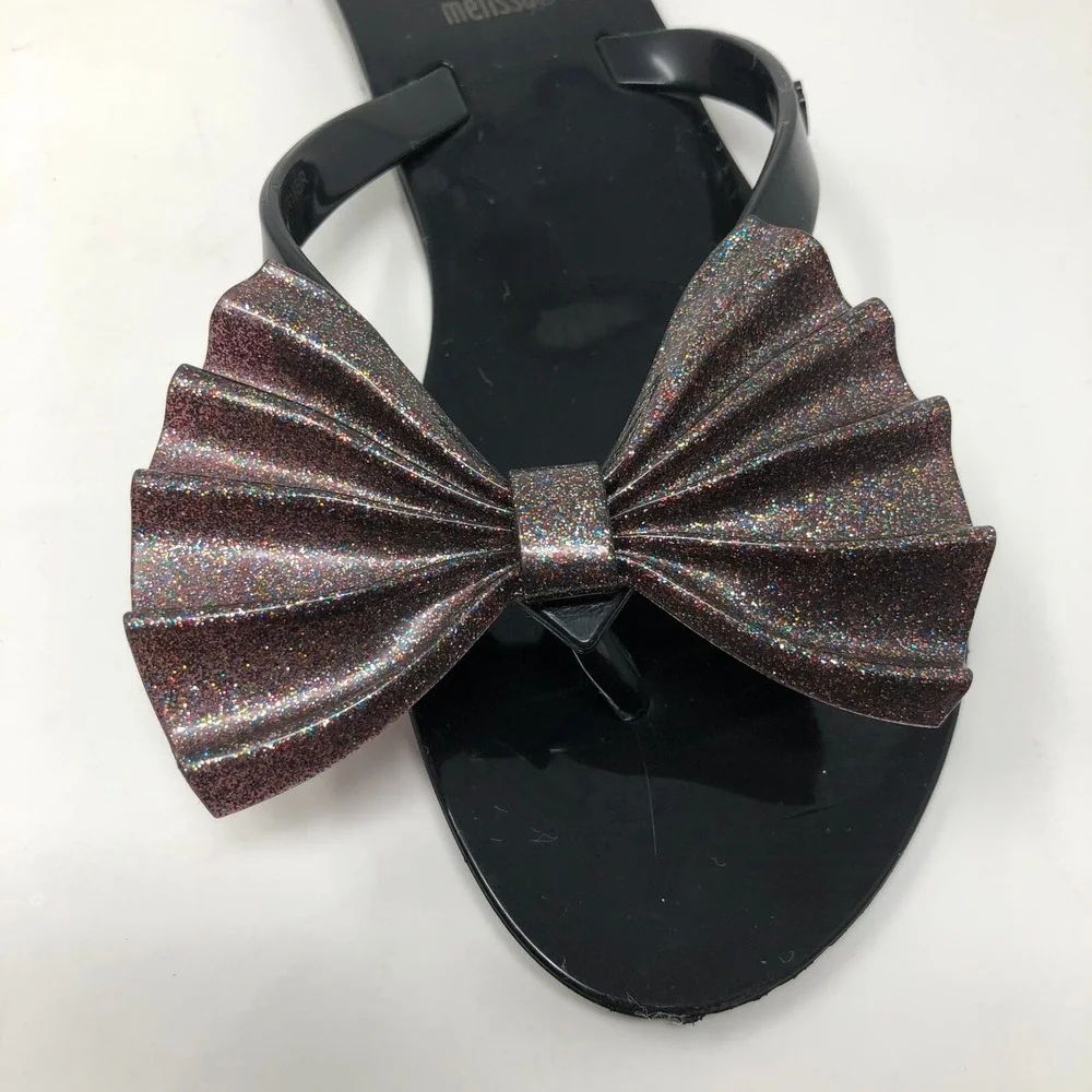 Melissa Mel Harmonic Bow Vi INF Flip Flops Girls 1 Black Glitter Scented